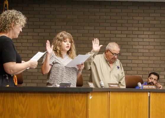  Pictured is re-elected board members Sandra Rivera, second from left, and Freddie Martinez, right. Executive Administrative Assistant Beverly Olson, left, conducted the oath while board member Flo Garcia, right, looked on. 