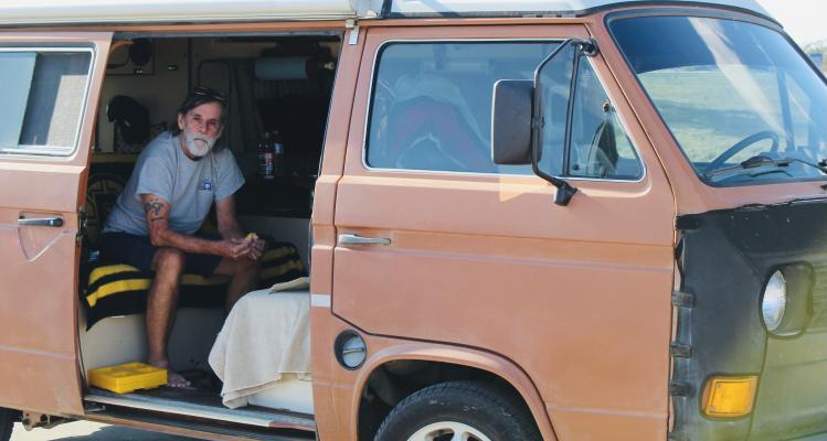 Bob Suzan quietly finished a sandwich in the Walmart parking lot. Tucked inside his 1983 air-cooled Volkswagen, the traveling widower took his shoes off and rested from his hours out on the backroads. 