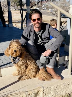 Ryan and his dog Jarvis relaxed on the edge of the Annie Riggs Museum porch during the Spring Fest music performance on Saturday. Photo by Jeremy Gonzalez