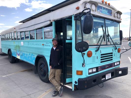 The Wells family has had many overnight stays at Fort Stockton’s Walmart. Husband and father, Chris Wells, stepped out of their bright-colored bus for a brief chat about parking lot camping. Photo by Jeremy Gonzalez