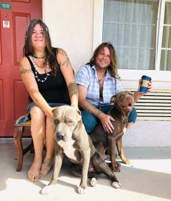 Travelers Sabra and Squirrel kicked back at the Budget Inn hotel with their dogs Dank and Modi. Typically, Dank is a very happy dog, but he didn’t smile for the camera in time. Photo by Jeremy Gonzalez