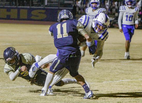 Fort Stockton senior Zane Hodges breaks through a pair of tackles on his way to his first touchdown of the season during Friday’s away contest at Fabens. Photo by Nathan Heuer