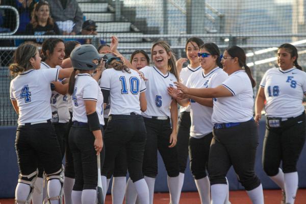 Aislynn Robledo (10) is embraced by her teammates after hitting a home run in the second inning of Tuesday’s game against Kermit. Robledo finished the game with two hits, two RBIs, and two runs in three at-bats. Photo by Nathan Heuer