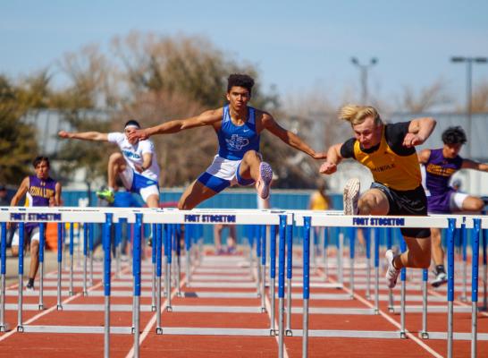 Fort Stockton junior Zane Hodges, middle, clears a hurdle in the 110-meter hurdles race on Saturday at the Comanche Relays. Hodges finished second in the event in his first competition of the season. Photo by Nathan Heuer