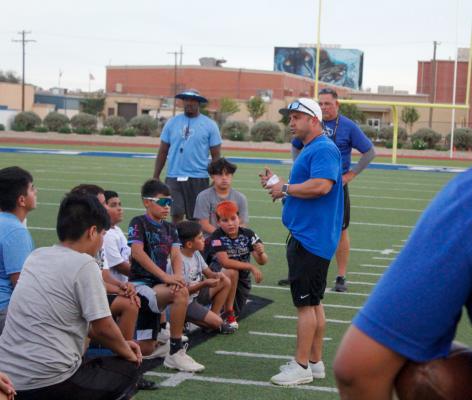 Coach Hickman speaks to his team after the first day of football camp on July 26.