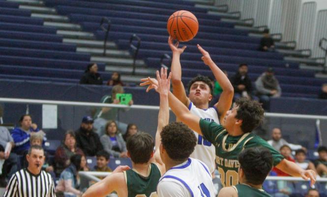 Fort Stockton junior Marco Garcia, middle, takes a mid-range jumper on Jan. 3 against Fort Davis. Garcia scored eight points against Van Horn, marking the sixth time this season he has reached the point total. Photo by Nathan Heuer
