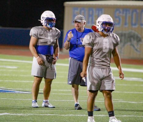 Running back Corbin Luna being coached during a drill.
