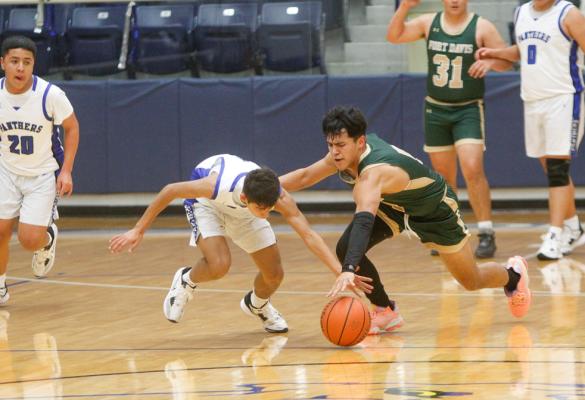Fort Stockton freshman Diego Ronquillo fights for a steal with Fort Davis’ George Ramon during the second half of Tuesday’s non-district contest. Ronquillo proved to be a valuable 3-and-D guard for the Panthers in the win at the Special Events Center. Photo by Nathan Heuer