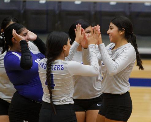 Senior Amaya Urias, right, exemplifies her joy with teammates after scoring a point during last week’s home opener against Wink. Photo by Nathan Heuer