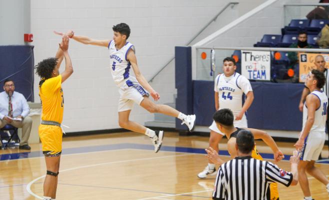 Fort Stockton senior Aryan Hernandez (5) soars to contest a 3-point shot by John Cottrell during Monday’s contest at the Special Events Center. Photo by Nathan Heuer