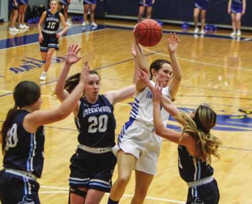 Fort Stockton’s Kylie Ruiz, white jersey, passes the ball out of a triple team in the second half of Tuesday’s contest at home against Greenwood. Photo by Nathan Heuer
