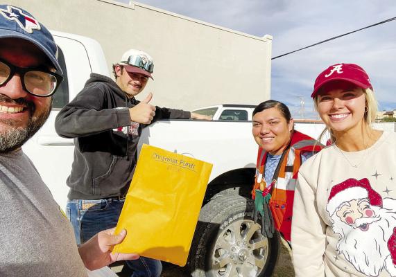 Andres Madrid of the Fort Stockton Rotary Club loads up toys for delivery with the help of several employees from Mortenson. Courtesy photo
