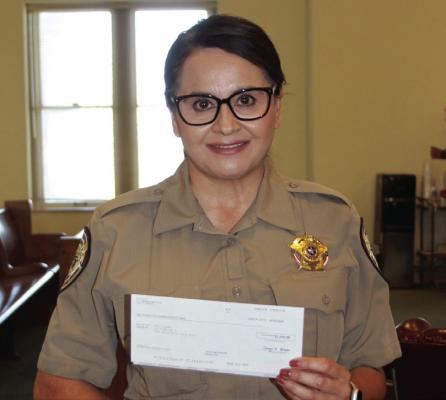 Pecos County Sheriff’s Office Chief Deputy Abby Ramirez presented a $2,500 donation check from XTO Energy to the Pecos County Commissioners Court.