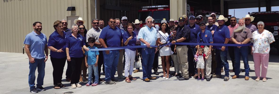 Judge Joe Shuster and recently crowned Miss Fort Stockton Aubrey Salgado assist Jessie Dominguez, Emergency Management Coordinator, with the ribbon-cutting ceremony at the new southside fire station. The Chamber of Commerce hosted the ribbon-cutting ceremony for the community and business leaders at the new southside fire station on Monday, July 29. Photo by Kerry Waldrip