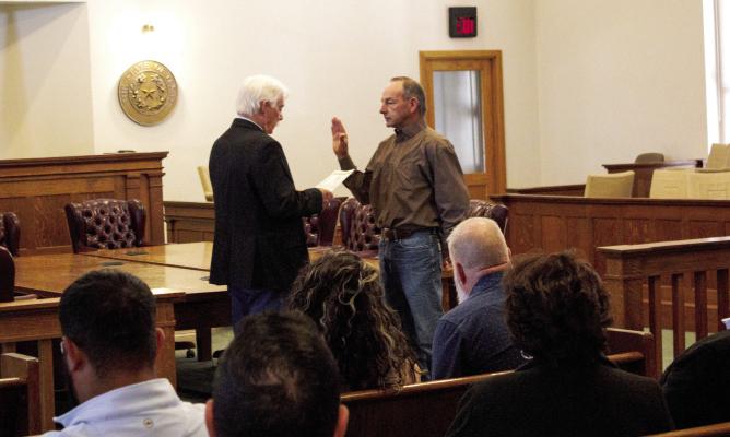 Pecos County Judge, Joe Shuster, swears Commissioner Mickey Jack Perry in, renewing Perry’s service to Precinct 3, on January 1. Photo by Joh Covington