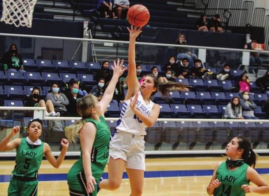 Fort Stockton’s Ariel Smith (10) attempts a 2-point shot in the paint during the fourth quarter of Tuesday’s home game against Monahans. (Photo by Nathan Heuer)
