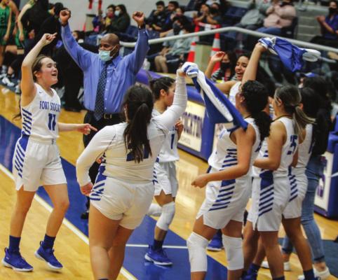 The Fort Stockton girls basketball team celebrates with their head coach Sherman Chew after Tuesday’s victory vs. Monahans. (Photo by Nathan Heuer)