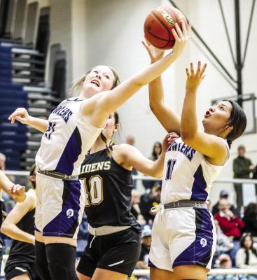 Kimbree Norman (21) reaches for a rebound in Friday’s loss to Seminole. Photos by Shawn Yorks