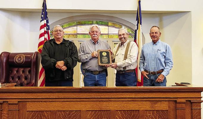 Left to right, commissioner Robert Gonzales, Judge Joe Shuster, and commissioners Tom Chapman and Mickey Jack Perry.