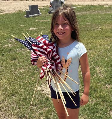 Caitlyn Bennet and her family with the help of many happy faces removed all the flags after the day of remembrance. Courtesy photo