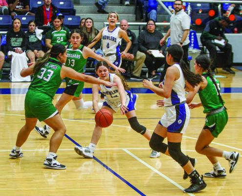Freshman guard Victoria Maldanado, middle, completes a bounce pass to Amaya Urias under the outreached armed of Monahans’ Bethanie Sanchez (33) in the first half of Friday’s contest at the Special Events Center. Photo by Nathan Heuer