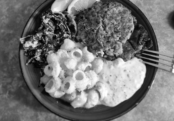 Crab cakes with arugula and lemon pasta. Photo by Kara Gerbert