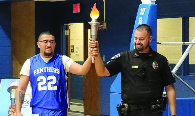 Mario Figueroa and Jordan Falcon carried the torch for the Law Enforcement Torch Run.
