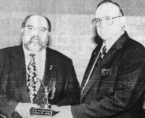 March 1998: CITIZEN OF THE YEAR: 1997 Citizen of the Year Reverend Jim Miles, left, is congratulated by thr 1996 Citizen of the Year, Roy Armstrong.