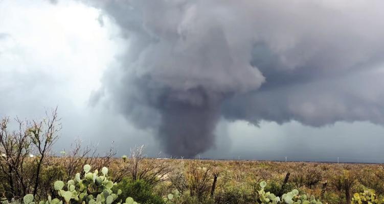 TWO TORNADOES CONFIRMED — A large tornado moves across a pasture near Fort Stockton on Oct. 14 as severe weather swept through Pecos County. The National Weather Service later confirmed two separate tornadoes: an EF0 that struck near downtown Fort Stockton and the Pecos County Courthouse, followed minutes later by an EF1 northeast of the city. Despite damage to trees, buildings, and property, no injuries or deaths were reported. Courtesy Photo by Kirby Warnock