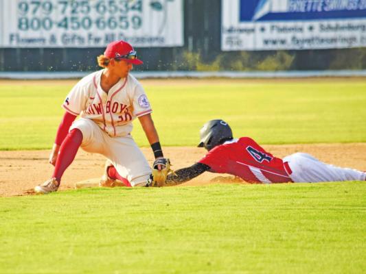 Cowboys shortstop Manny Garcia tags out Demarcus Kelly of the Weimar Hormigas on a stolen base attempt during a regular season game at Weimar Veterans Park on June 21. Photo by Julie Myers