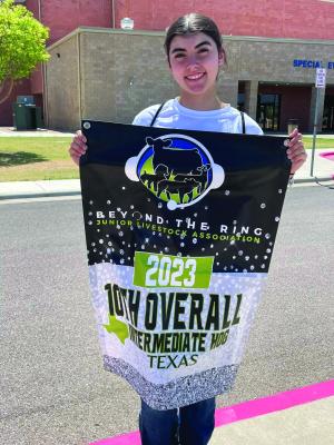 Carla Poses with her banner she received last month for last year’s competition. Photo provided by Jamie Vazquez