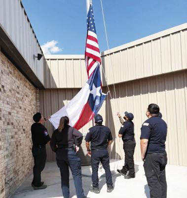 The Pecos County EMS, C Shift, replacing the old US Flag at the EMS Station in Fort Stockton with the new. Courtesy Photo by Pecos County EMS