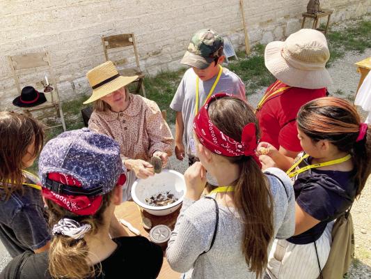 Young history enthusiasts journeyed back to the Old West during the Living History Summer Camp on June 18, exploring the Annie Riggs Memorial Museum and Stockton Historic Fort through interactive lessons and demonstrations. Story on page 2. Courtesy Photos