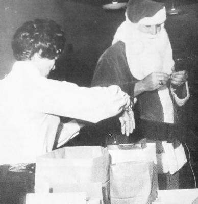 LEFT: December 1969: SANTA AT SCHOOL – Santa Claus does the honors at Fort Stockton Junior High School, distributing gifts with the assistance of Mrs. Sammie Pfeister, the school secretary. Principal Ken Fields read a list of Merchants who helped fill Santa’s bag for the Christmas Friday at the school. Photos are from the Fort Stockton Pioneer archives at the Pioneer’s office located at 210 N. Nelson St.
