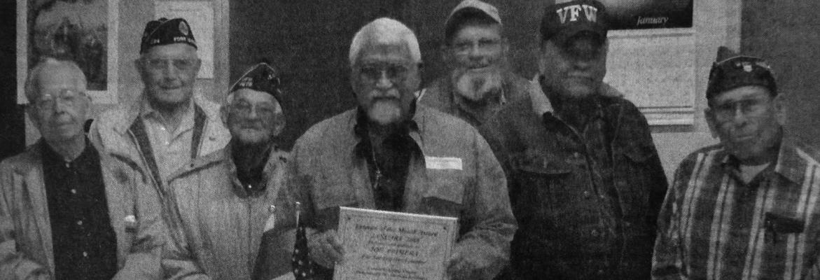 January – 2008 — Veterans Henry Castello, Antonio Benevides, Robert Miller, Herman Diebitsch, Albert Fuentes and Manuel Nunez gather around Joe Primera as he holds the plaque presented to him by the DAR thanking him for his service to his country.