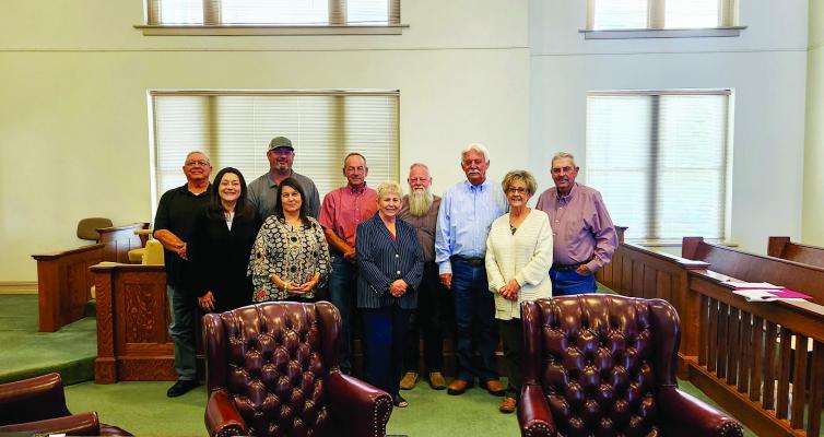 County Commissioners and county employees gather around Pct. Justice of the Peace, Donna Wooten, after accepting her resignation as she looks forward to her retirement. Photo by Joh Covington