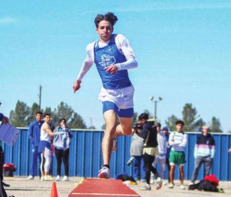Fort Stockton senior Caleb Garcia takes flight to the sandpit during the triple jump competition at the Comanche Relays on Feb. 26. Photo by Nathan Heuer