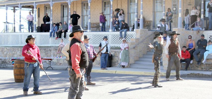 Spectators watch a fun gunslinger “gun fight” outside of the Annie Riggs Memorial Museum on Saturday. On November 22 the community gathered in the historic downtown Fort Stockton to celebrate the museum’s 70th anniversary. Food trucks, authors, and live music delighted those who attended. Photo by Joh Covington