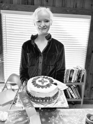 Kali Davis, standing with her cake with a lovely pecan design, won reserved first place. Courtesy Photos
