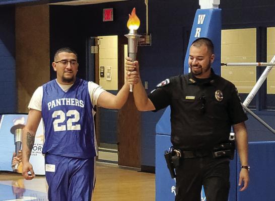 Mario Figueroa and Jordan Falcon carried the torch for the Law Enforcement Torch Run. Courtesy Photo