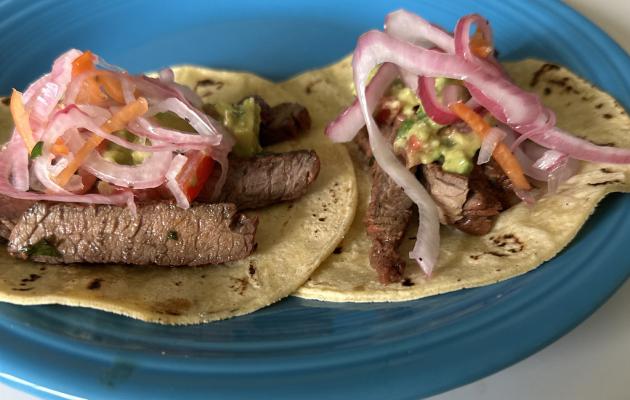Carne asada fajitas on corn tortillas with pickled red onions and guacamole. Photo by J.T. Maroney