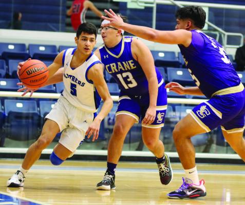 Fort Stockton senior Aryan Hernandez slithers through a Crane double team during the Panthers 55-40 loss on Dec. 15 at the Special Events Center. Hernandez scored a team-high 10 points in the contest. Photo by Shawn Yorks