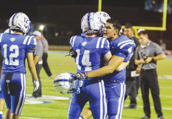 Fort Stockton starting defensive lineman Dominic Bernal (4) celebrates Friday’s win against Lake View with teammate Kye Norman (14). Photo by Nathan Heuer