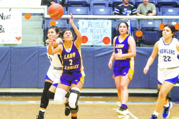Fort Stockton’s Estrella Aguilar battles for a loose ball with Pecos’ Leah Ramirez during the teams district matchup on Jan. 10. Photo by Nathan Heuer