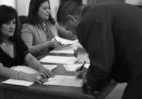 County Sheriff Thomas J. Perkins signs his name for another term of service to Pecos County. Photo by Joh Covington