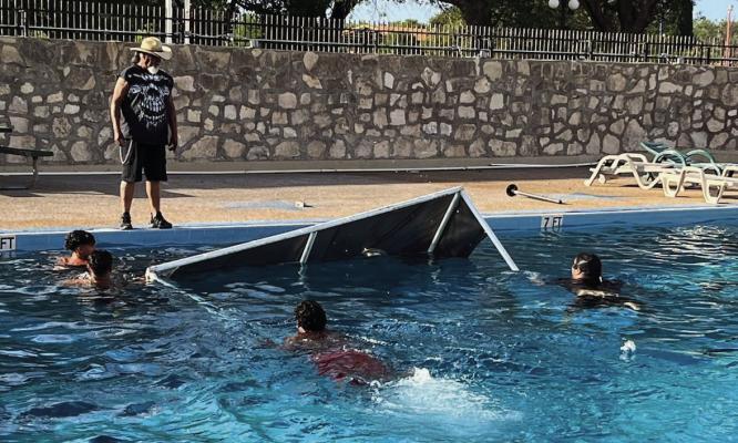On Independence Day, vandals dumped tables, lifeguard stands, covered awnings, chairs, and even a set of bleachers into the Comanche Springs swimming pool. They had also broken into a brand-new storeroom, ramming the slide-up door and back gate with the Gator vehicle. Photo by Robert Gonzales