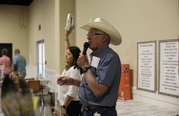 Paul Weatherby auctioning off cook brisket.