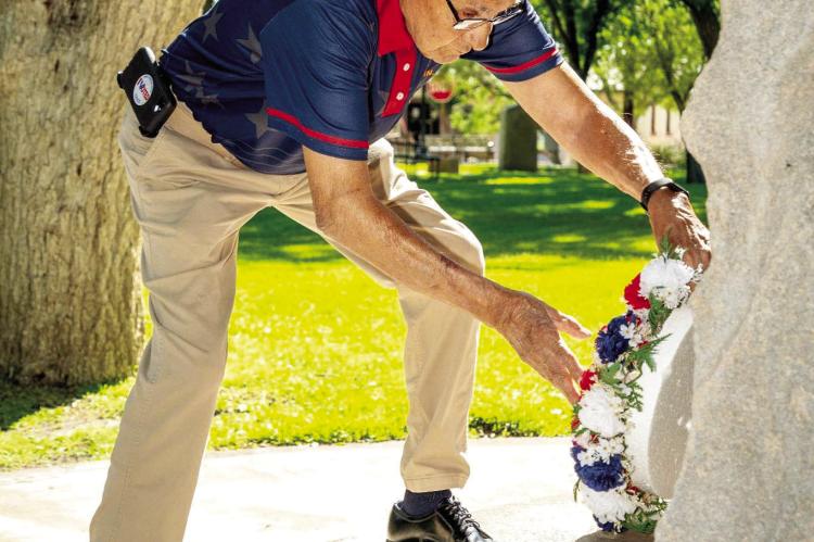 COMMEMORATIVE WREATHS — New commemorative wreaths, donated by Gerardo and Darla Pules, are displayed during the ceremony led by County Veteran Service Officer Michael Pules. Photo by Tristian Barragan