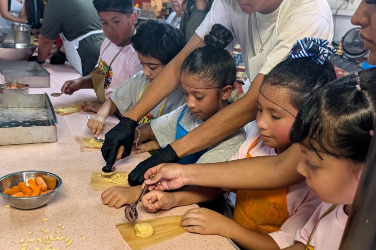 Alamo elementary learning to make tamales at barrio fest