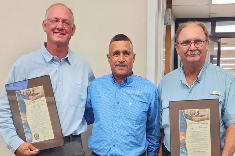 Mayor Paul Casias presented a proclamation recognizing Jeff Williams, left, and Patrick Blisnak, right, for their assistance and generosity during the situation. Courtesy Photo: Pioneer